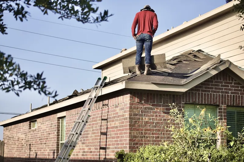 Professional roofer working on a residential roof in Augusta